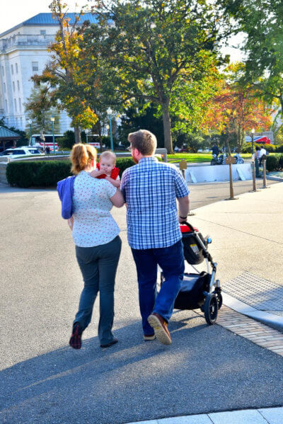 Family of three people, mom, dad and baby