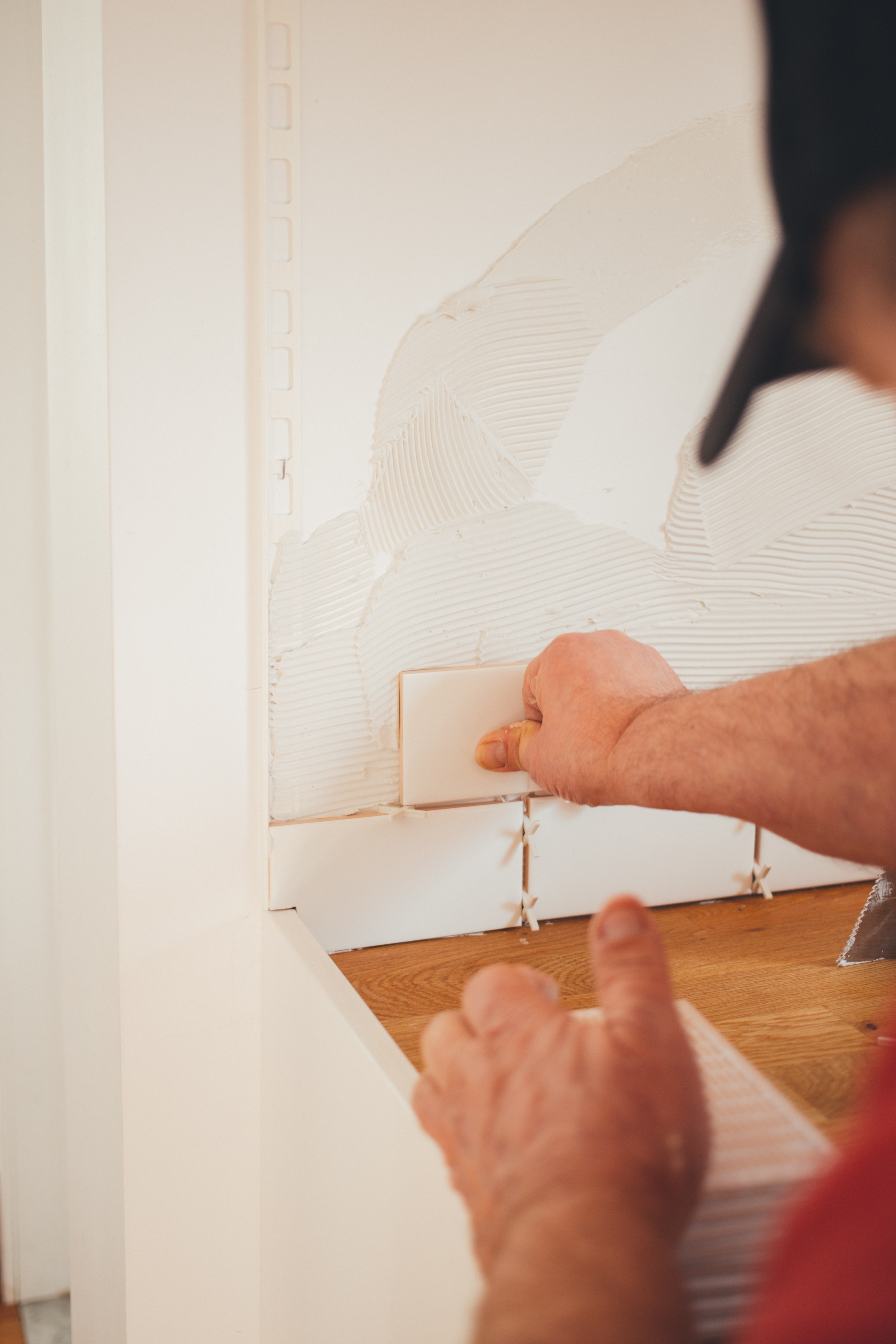 person fixing tile