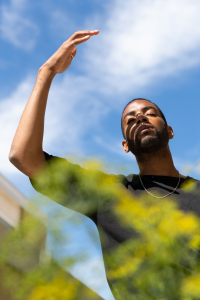 a person shielding the sun away with their hand