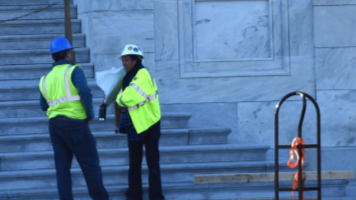 people in hard hats assessing a building on Capitol Hill