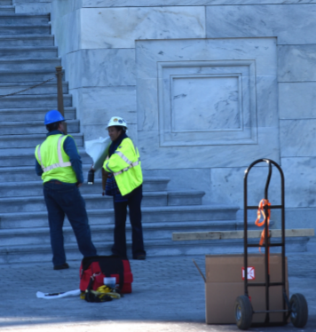 people in hard hats assessing a building on Capitol Hill